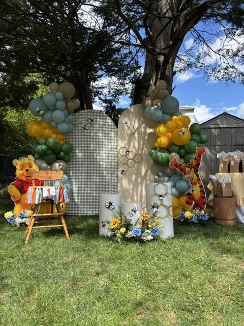Primer cumpleaños con globos verde salvia y amarillo y panales de abeja